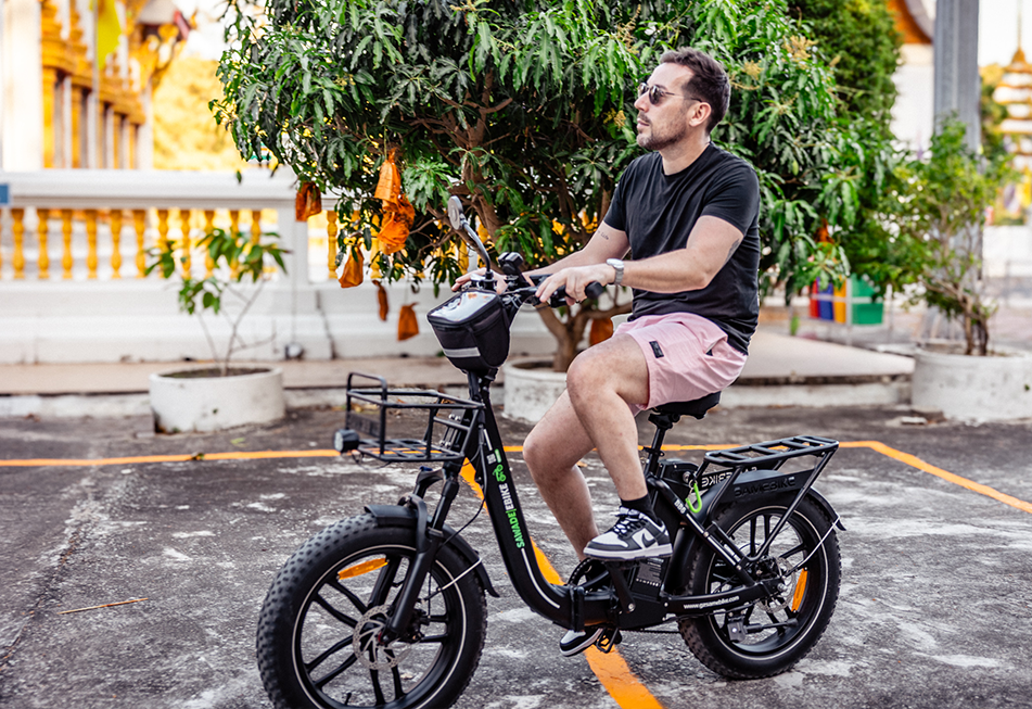 Man riding a Buddy Bike electric bicycle around Nai Harn temple in Phuket